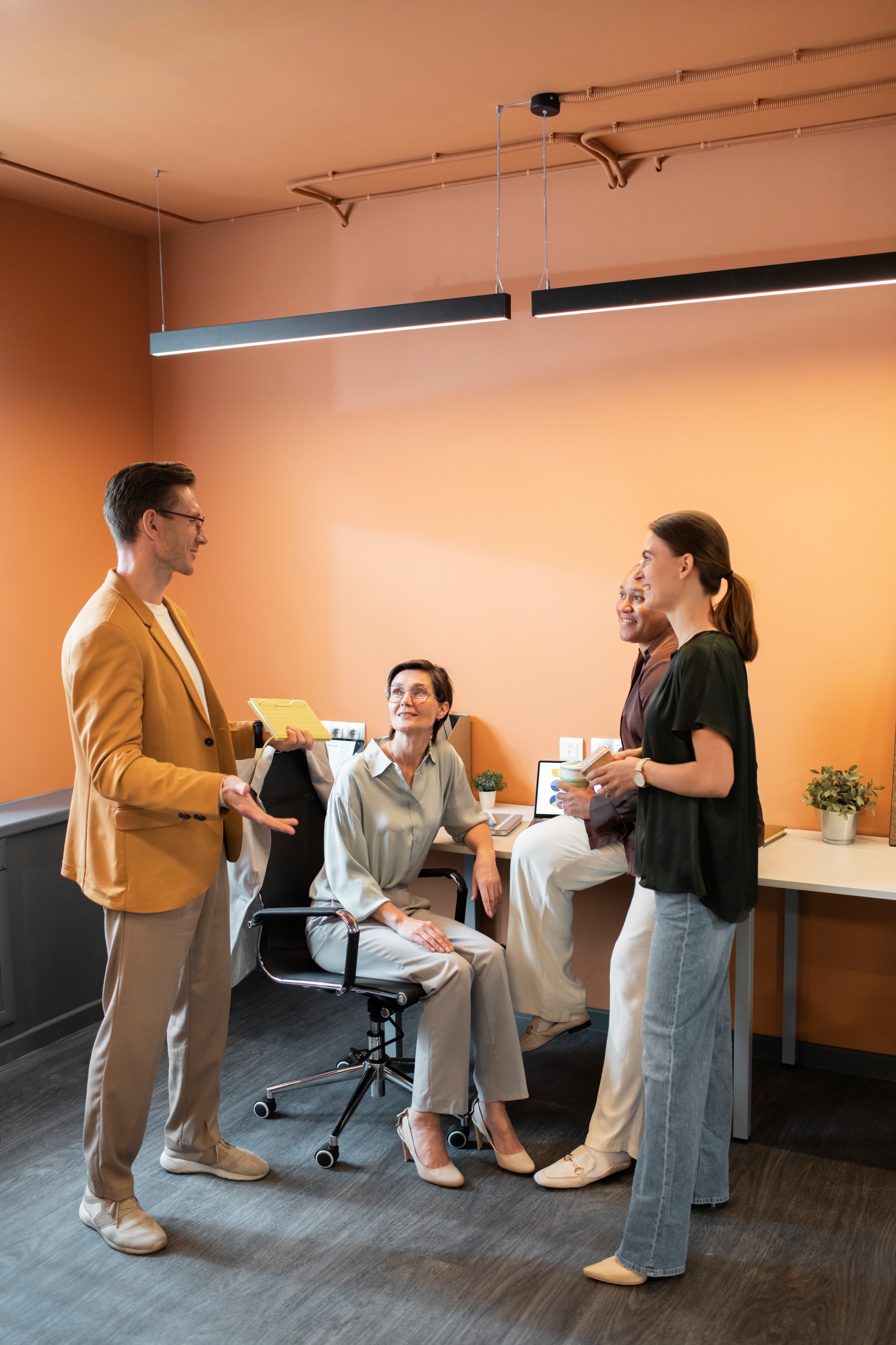 Team collaborating around a plant-filled workspace